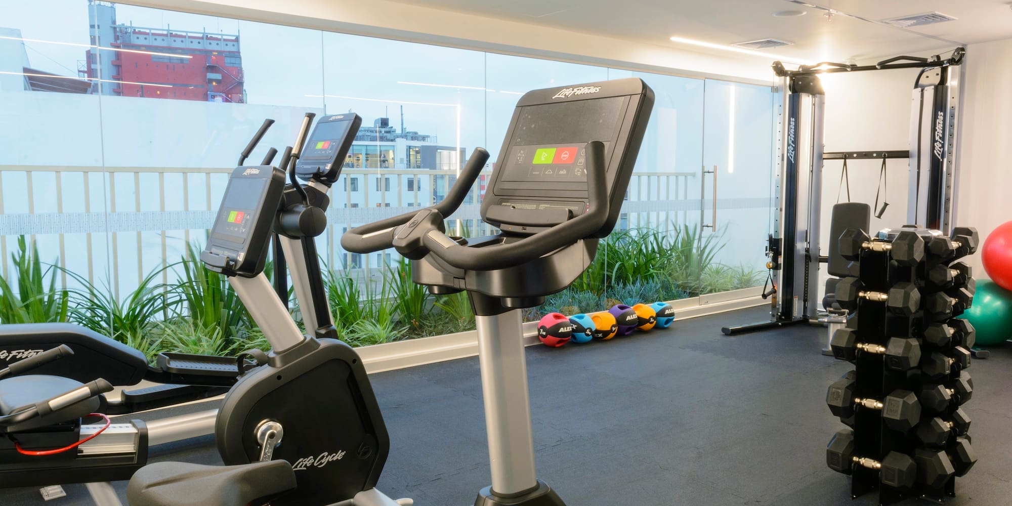 a room with exercise bikes and a large window