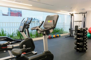a room with exercise bikes and a large window
