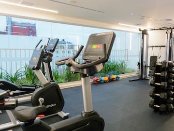 a room with exercise bikes and a large window