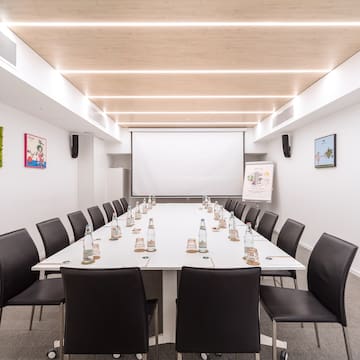 a conference room with a table and chairs