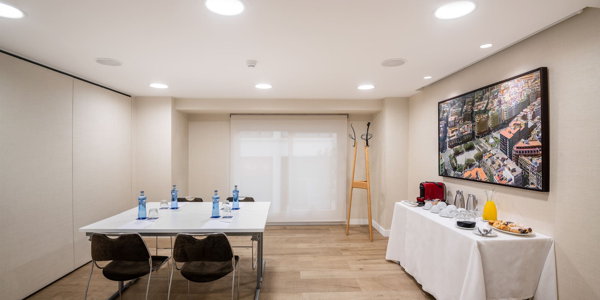 a room with a table and chairs and a television