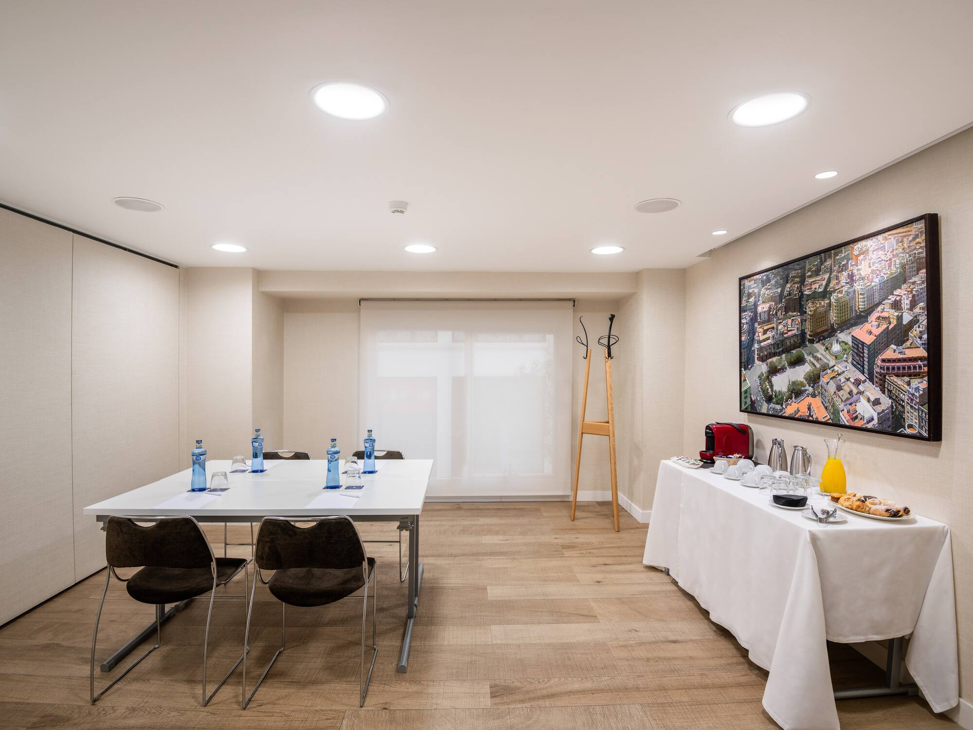 a room with a table and chairs and a television