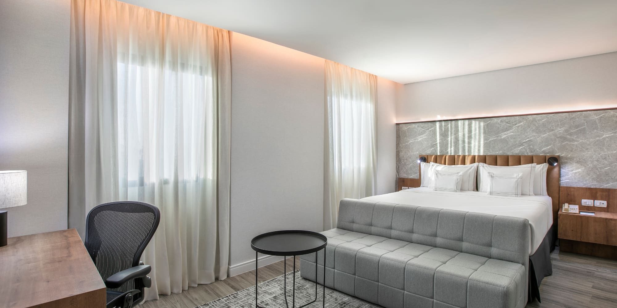 a bedroom with a bed and a desk