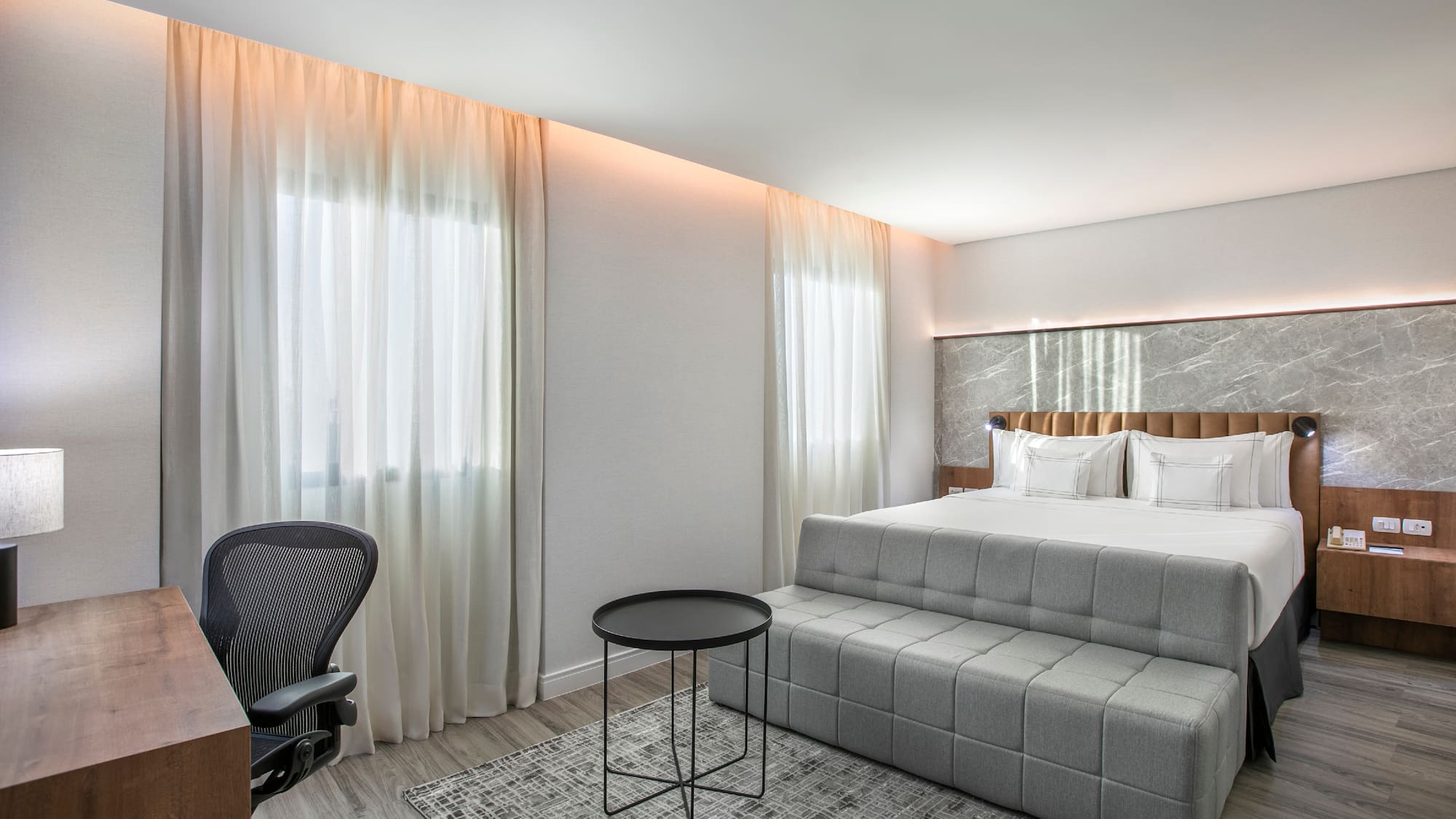 a bedroom with a bed and a desk