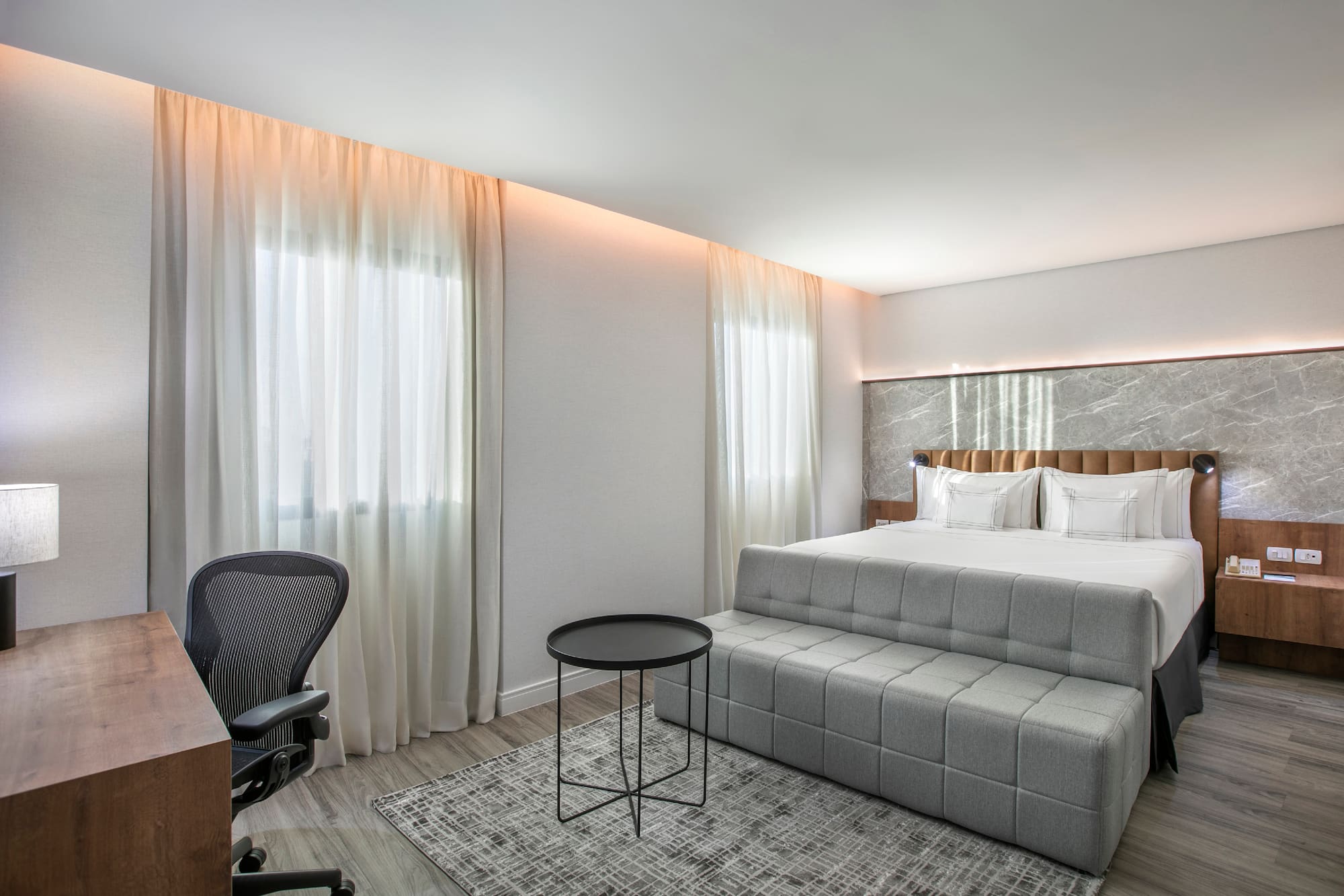 a bedroom with a bed and a desk