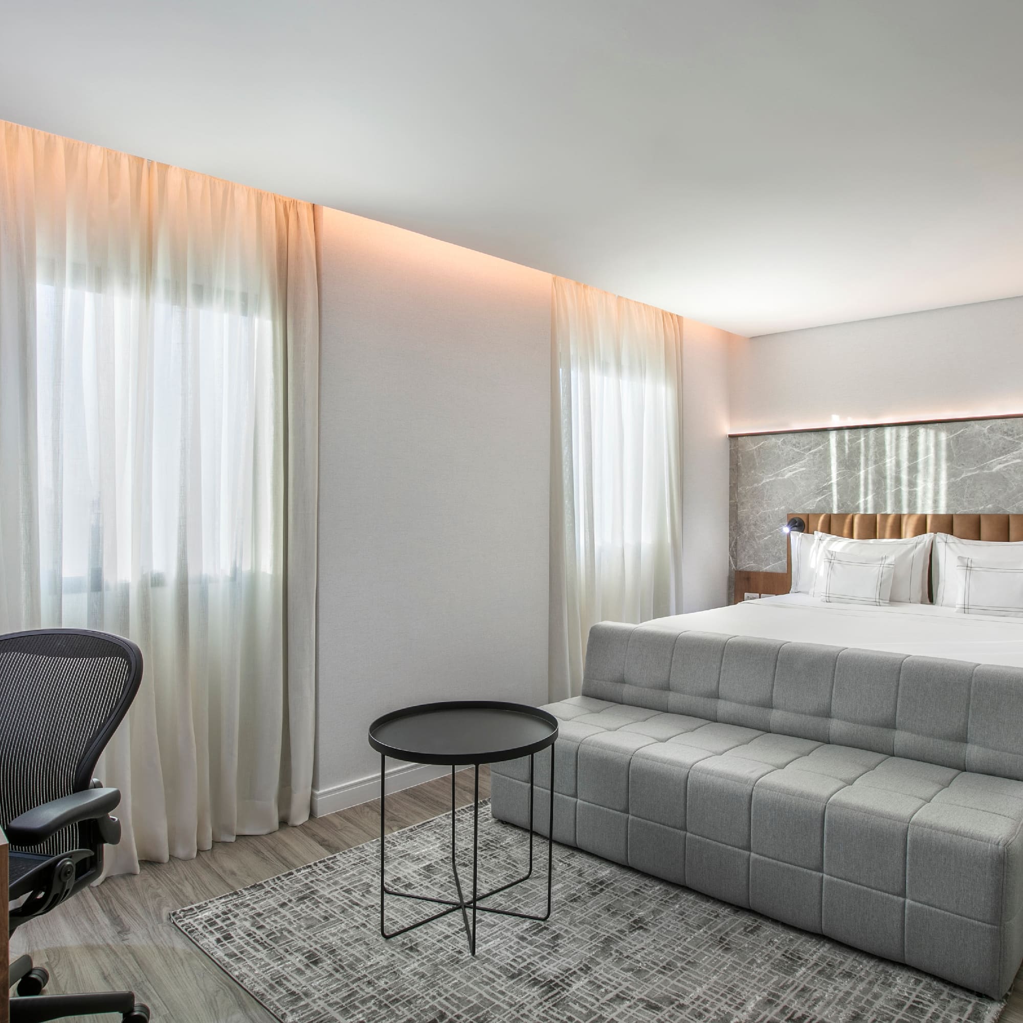 a bedroom with a bed and a desk