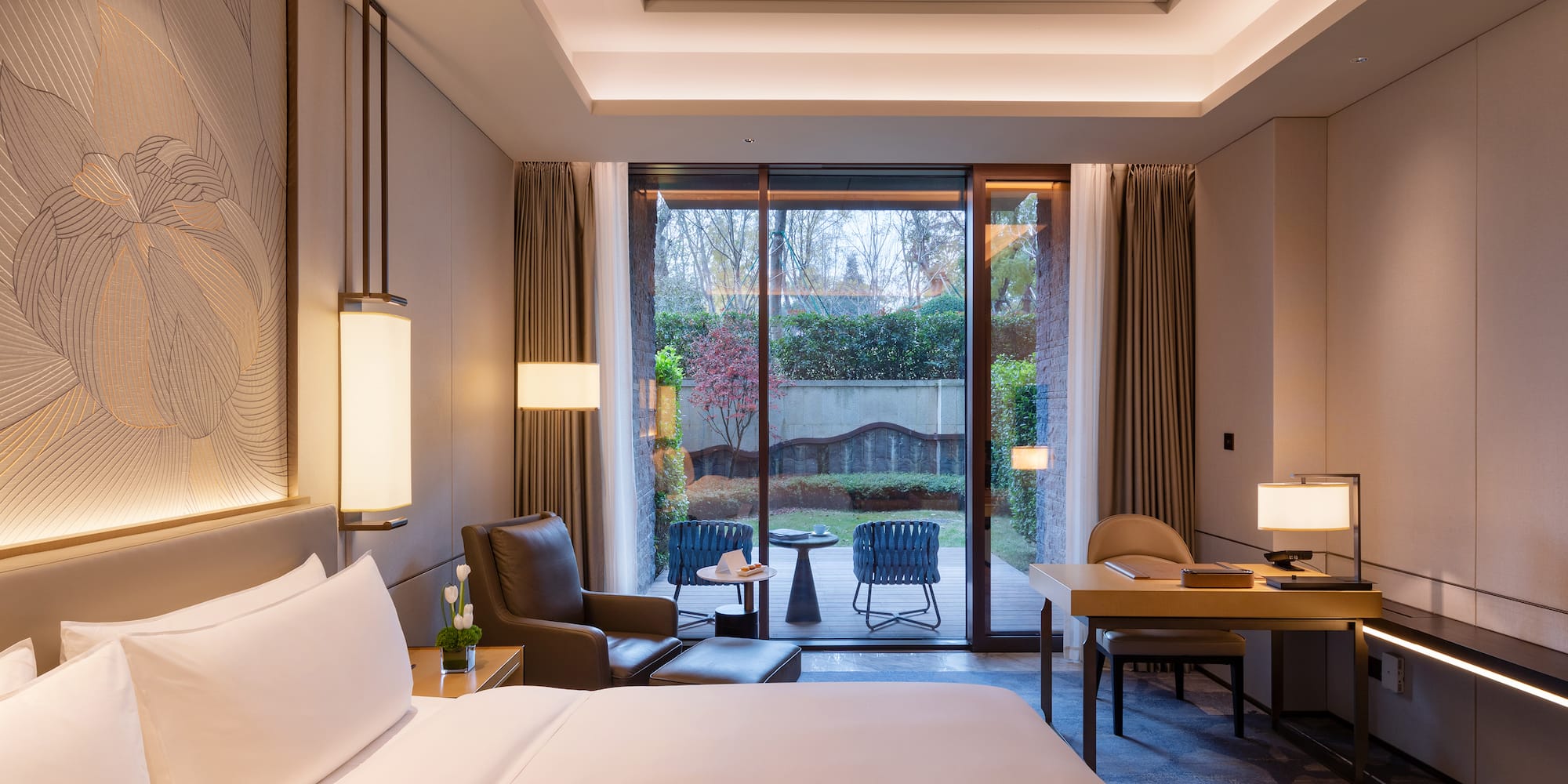 a room with a bed and a table and chairs