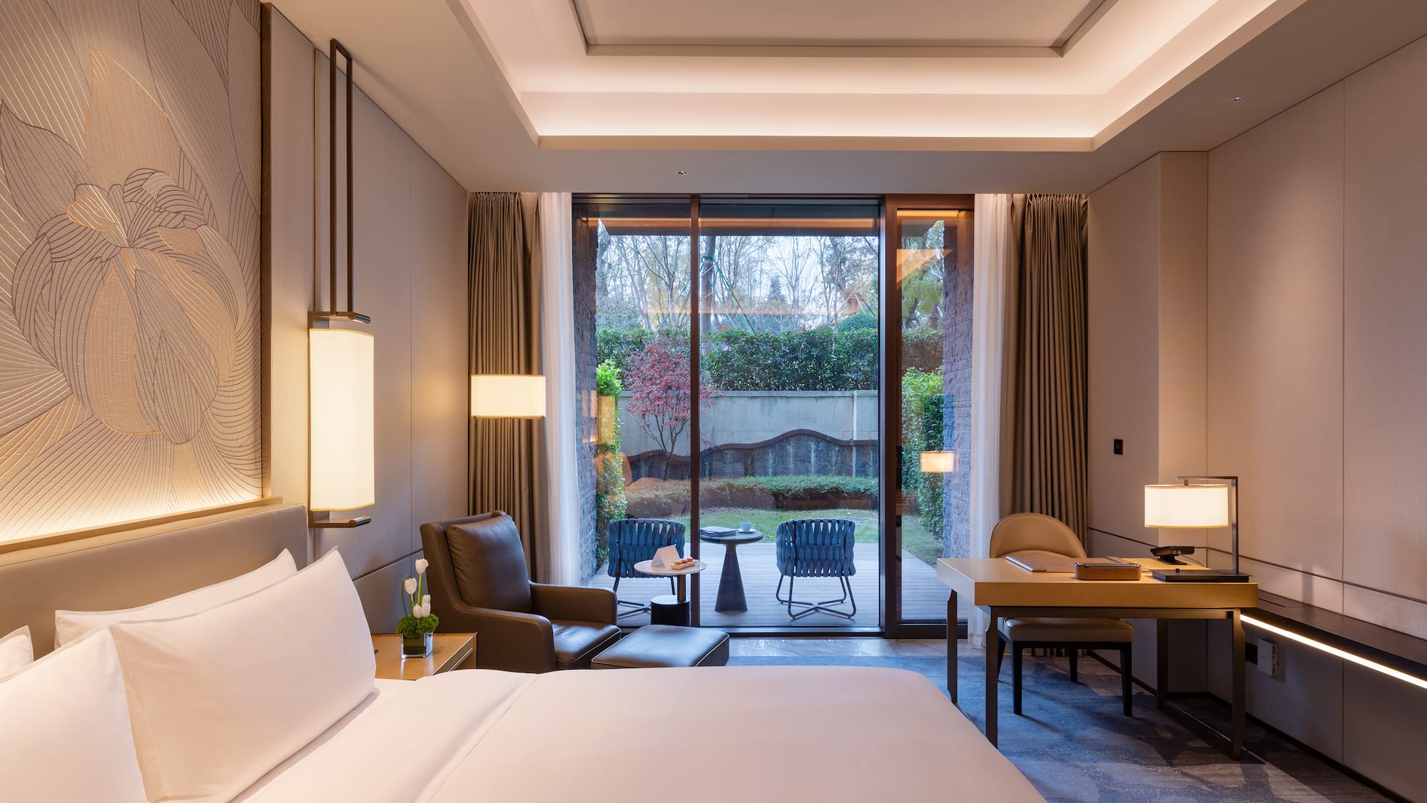 a room with a bed and a table and chairs