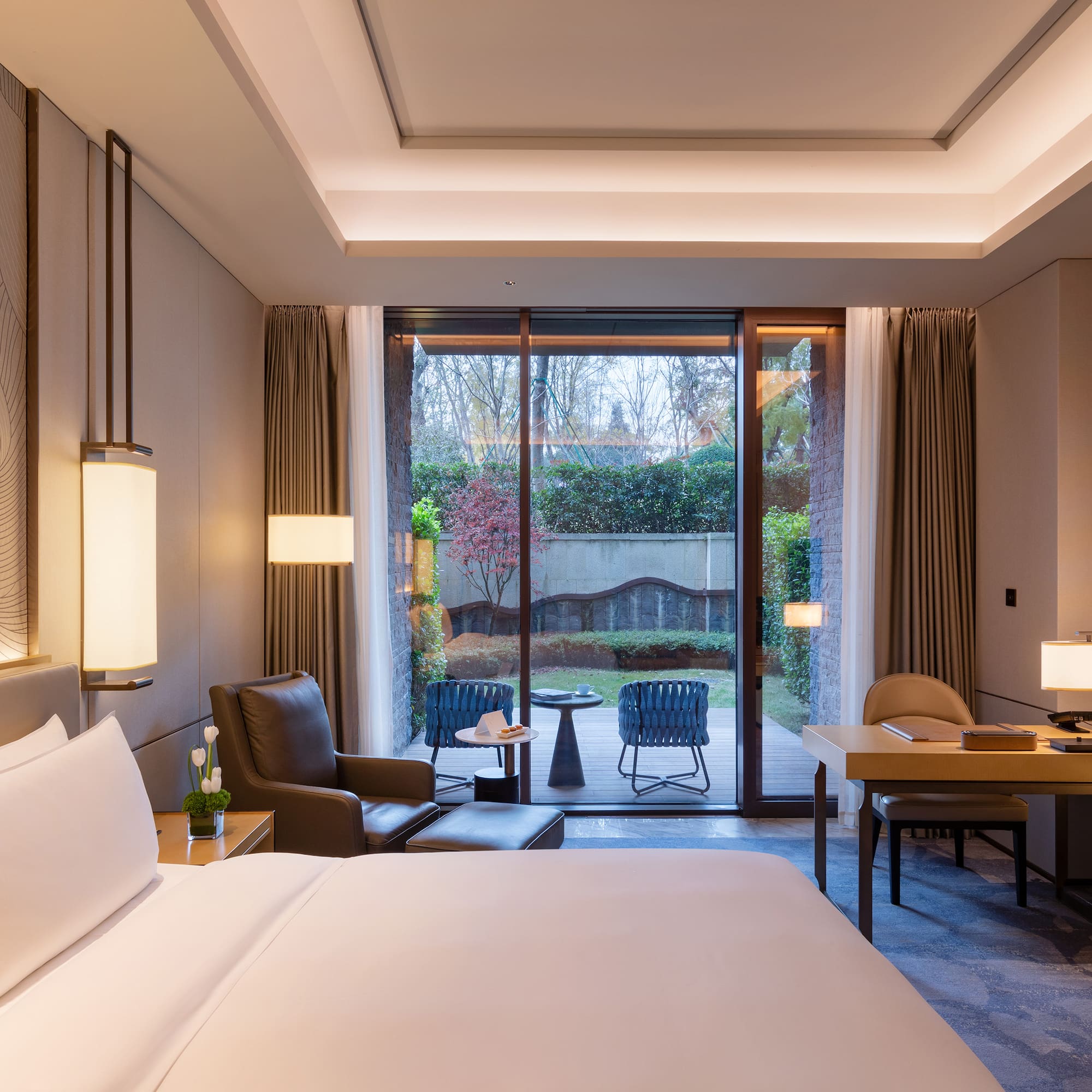 a room with a bed and a table and chairs