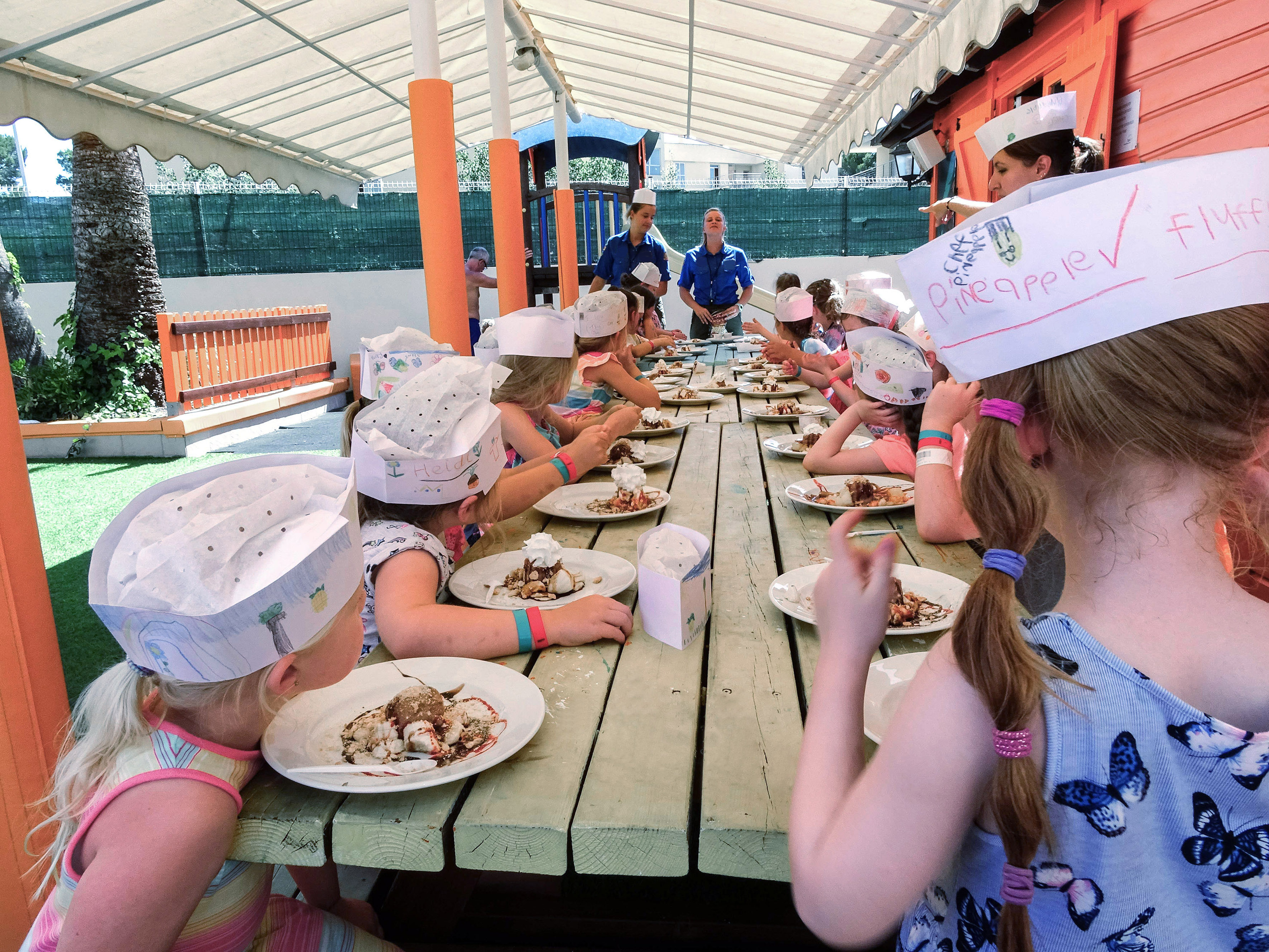 a group of children eating at a table