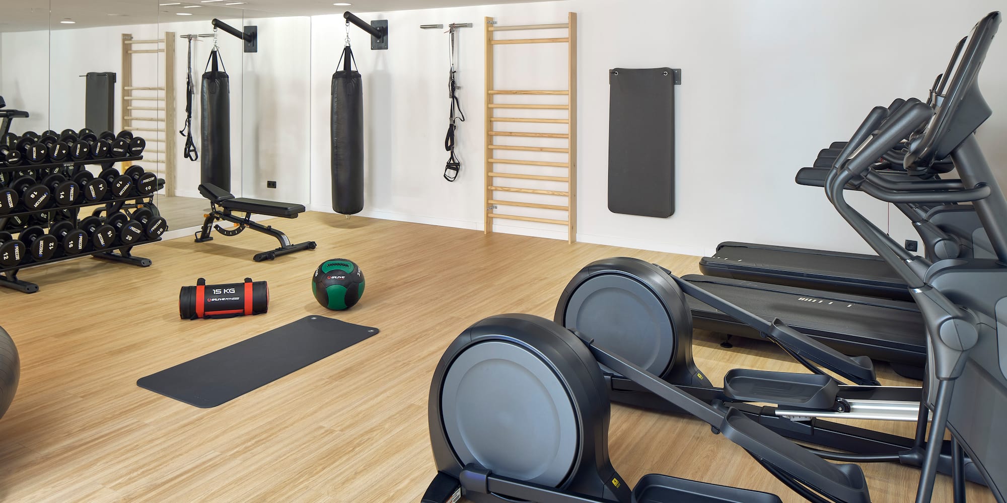 a room with exercise equipment and a ladder