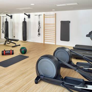 a room with exercise equipment and a ladder
