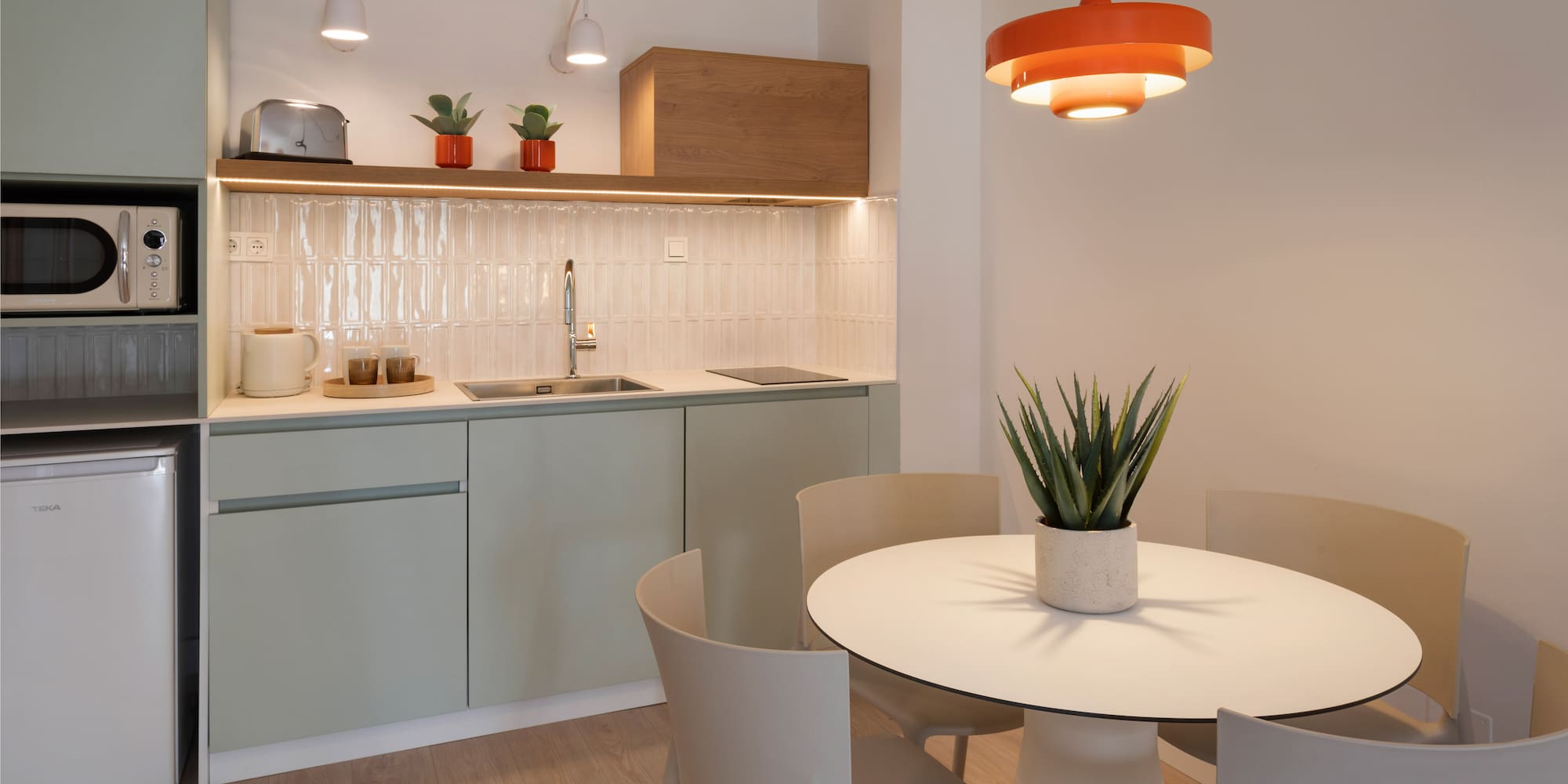 a kitchen with a table and chairs