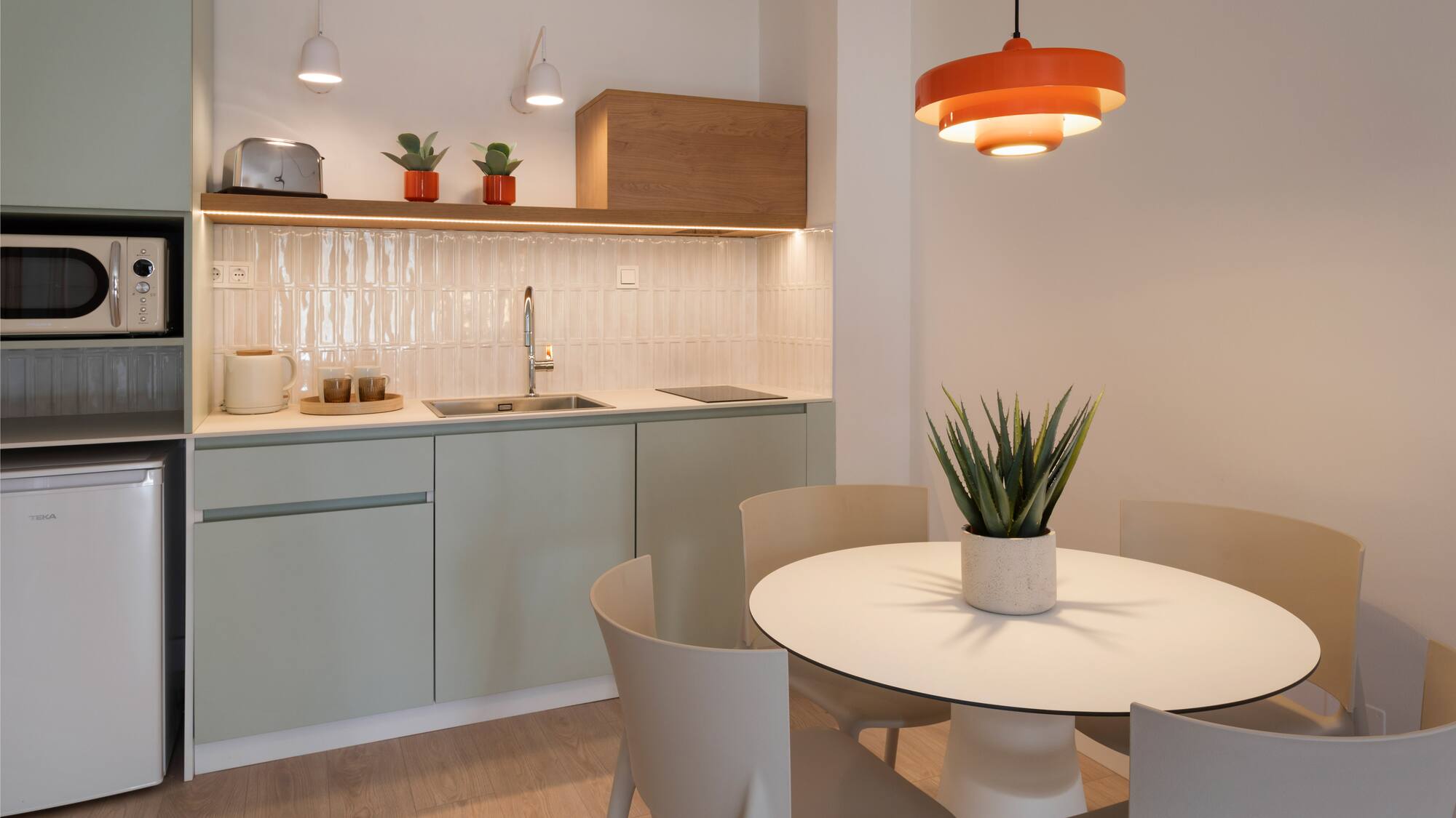 a kitchen with a table and chairs