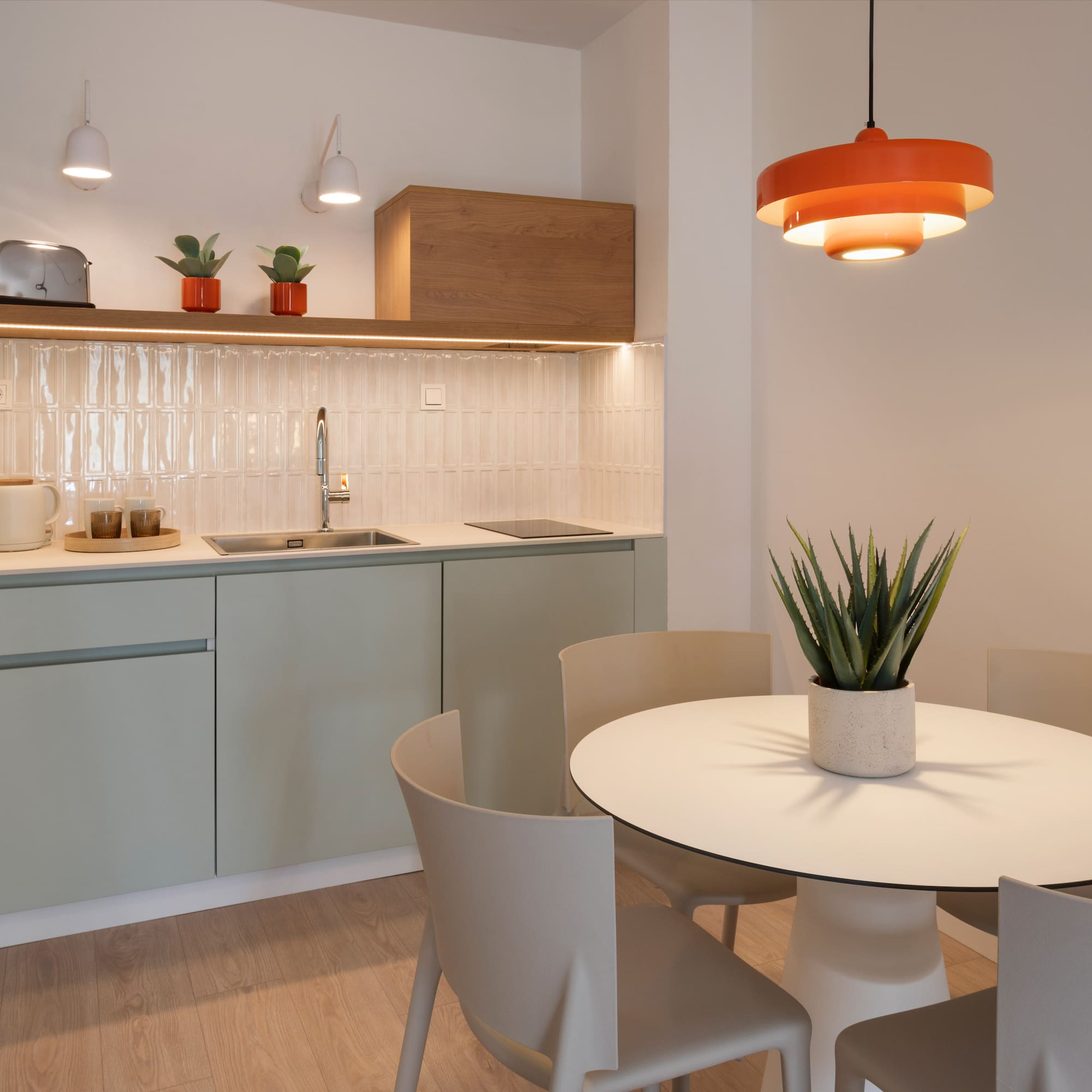 a kitchen with a table and chairs