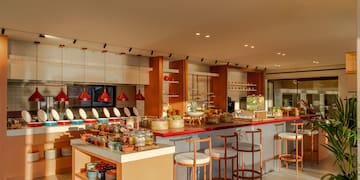 a kitchen with a counter and stools