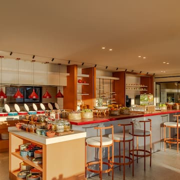 a kitchen with a counter and stools