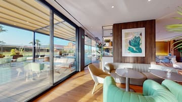 a room with a couch and chairs