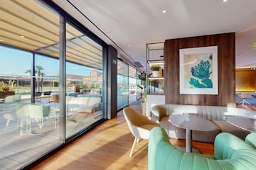 a room with a couch and chairs