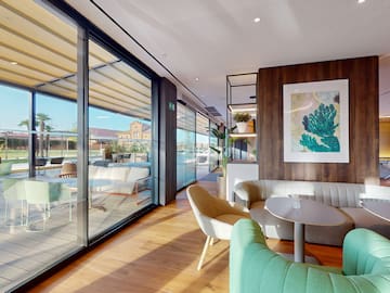 a room with a couch and chairs