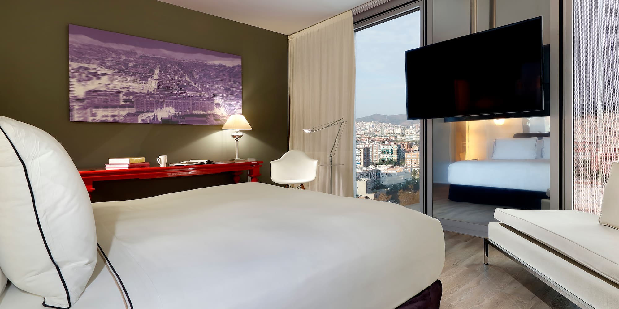 a bedroom with a bed and a television