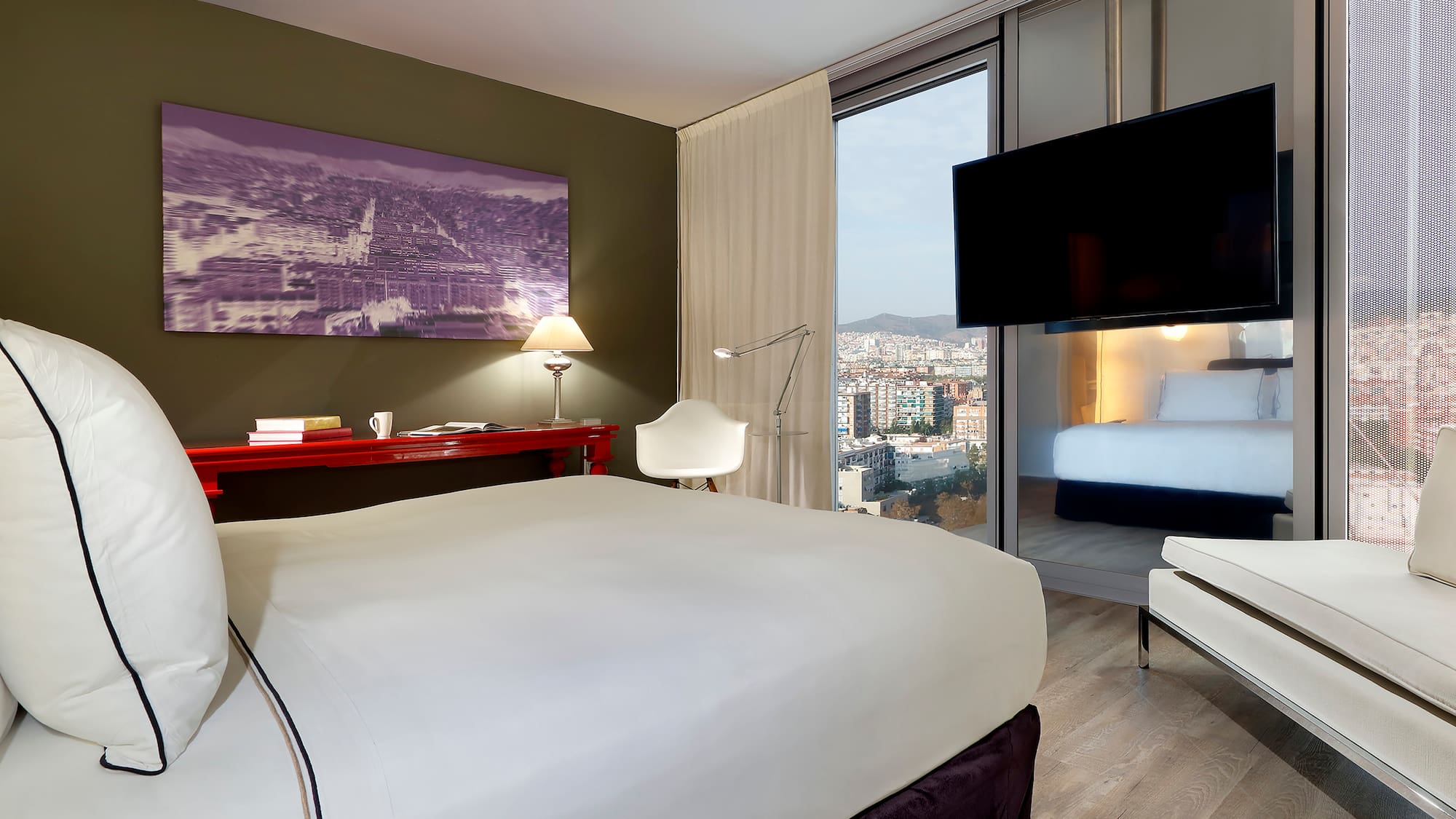 a bedroom with a bed and a television