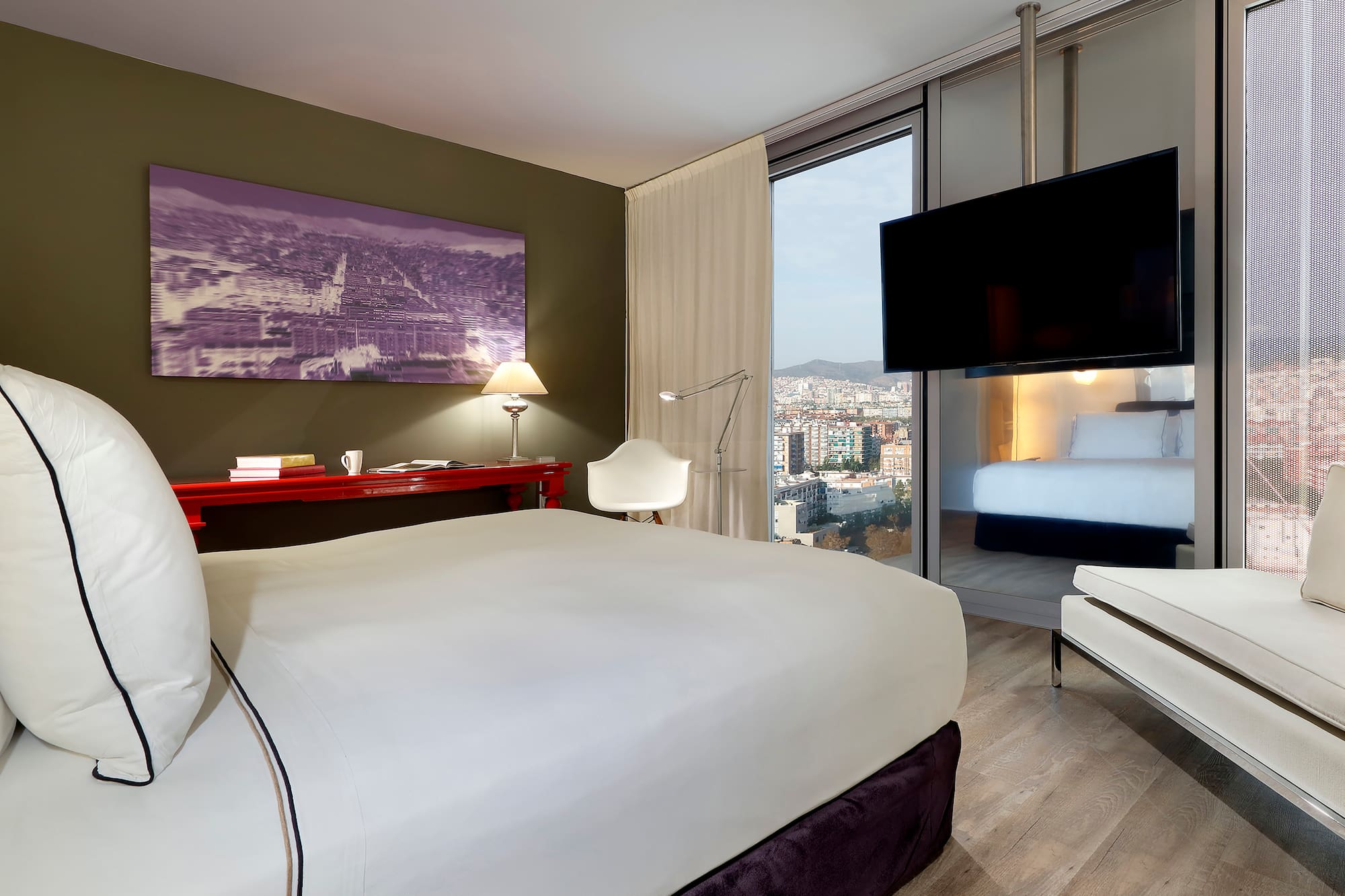 a bedroom with a bed and a television