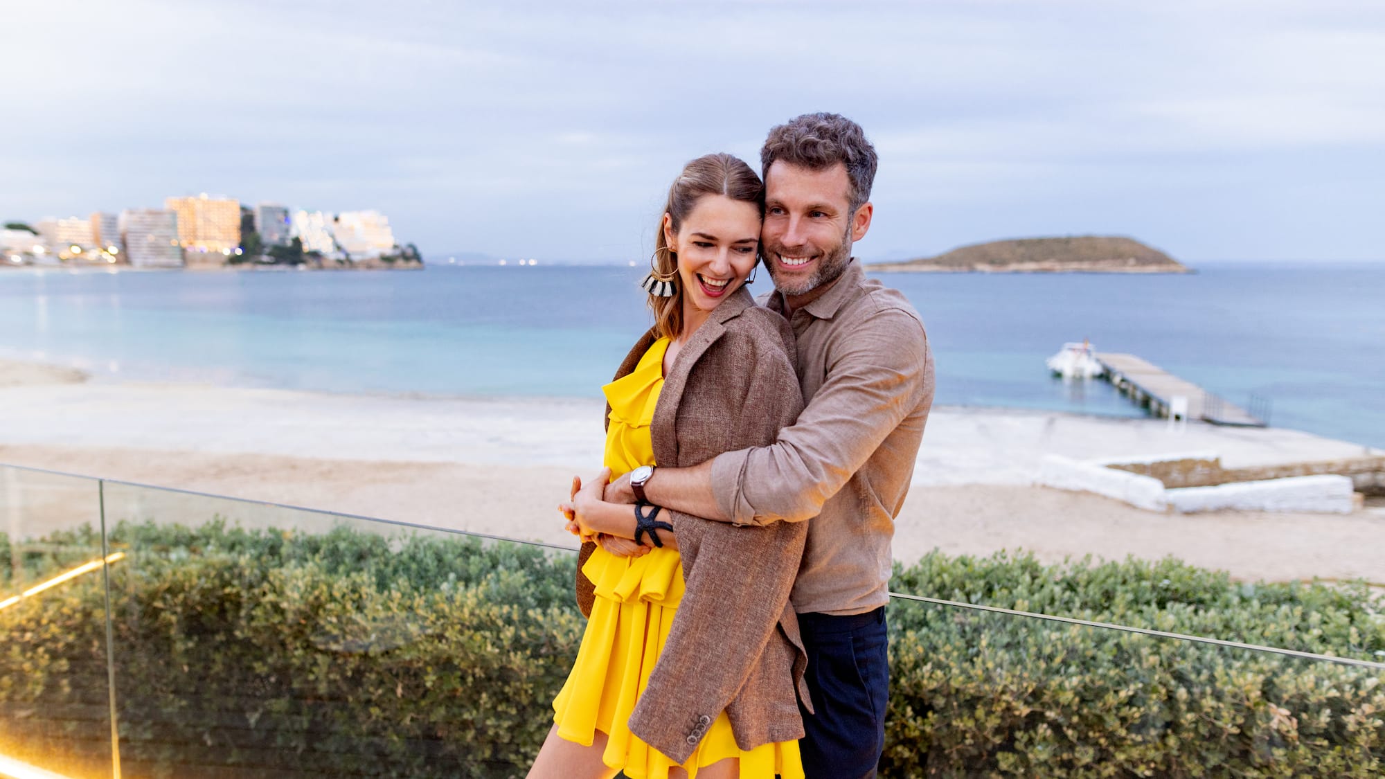 a man and woman hugging and smiling