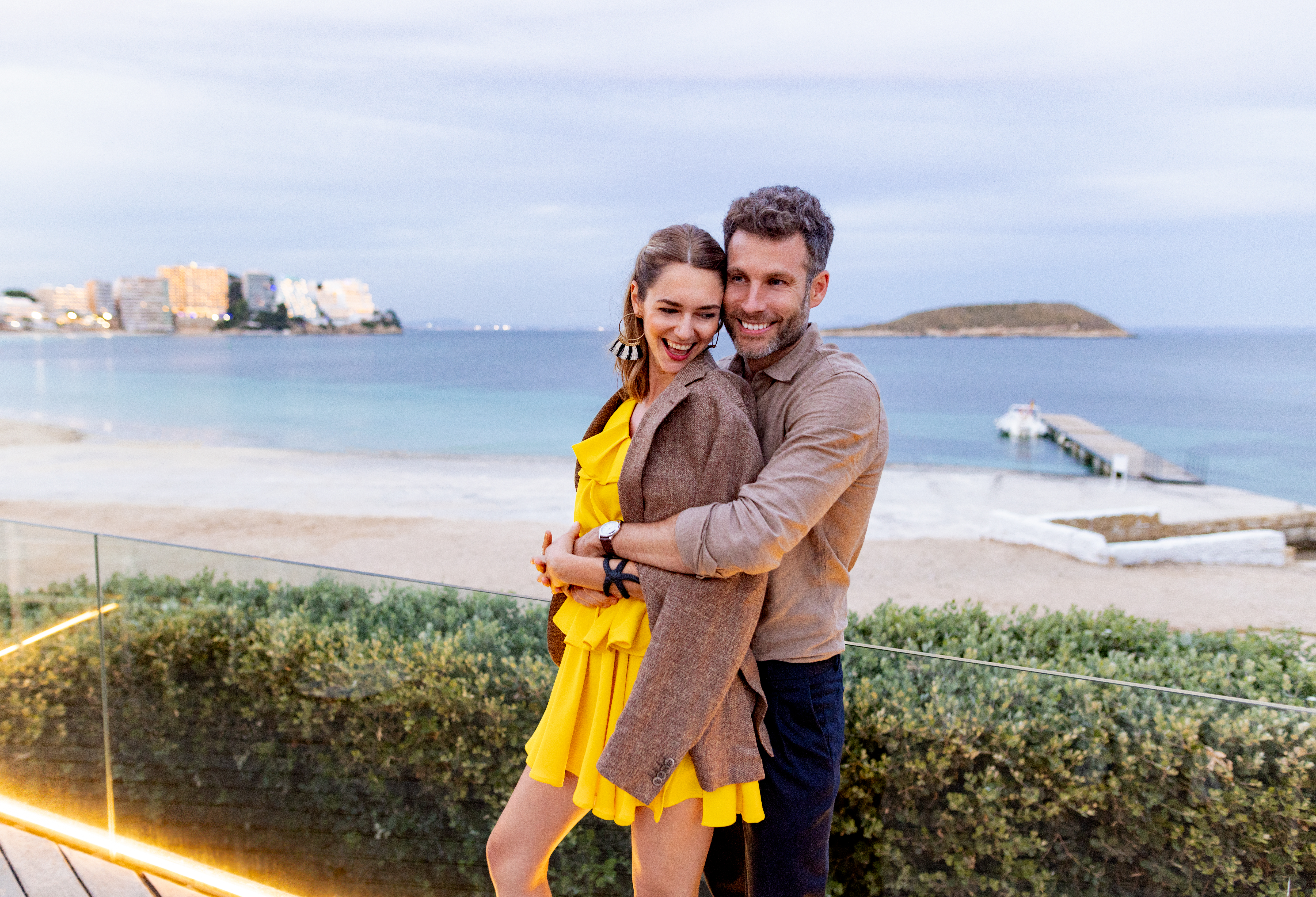 a man and woman hugging and smiling