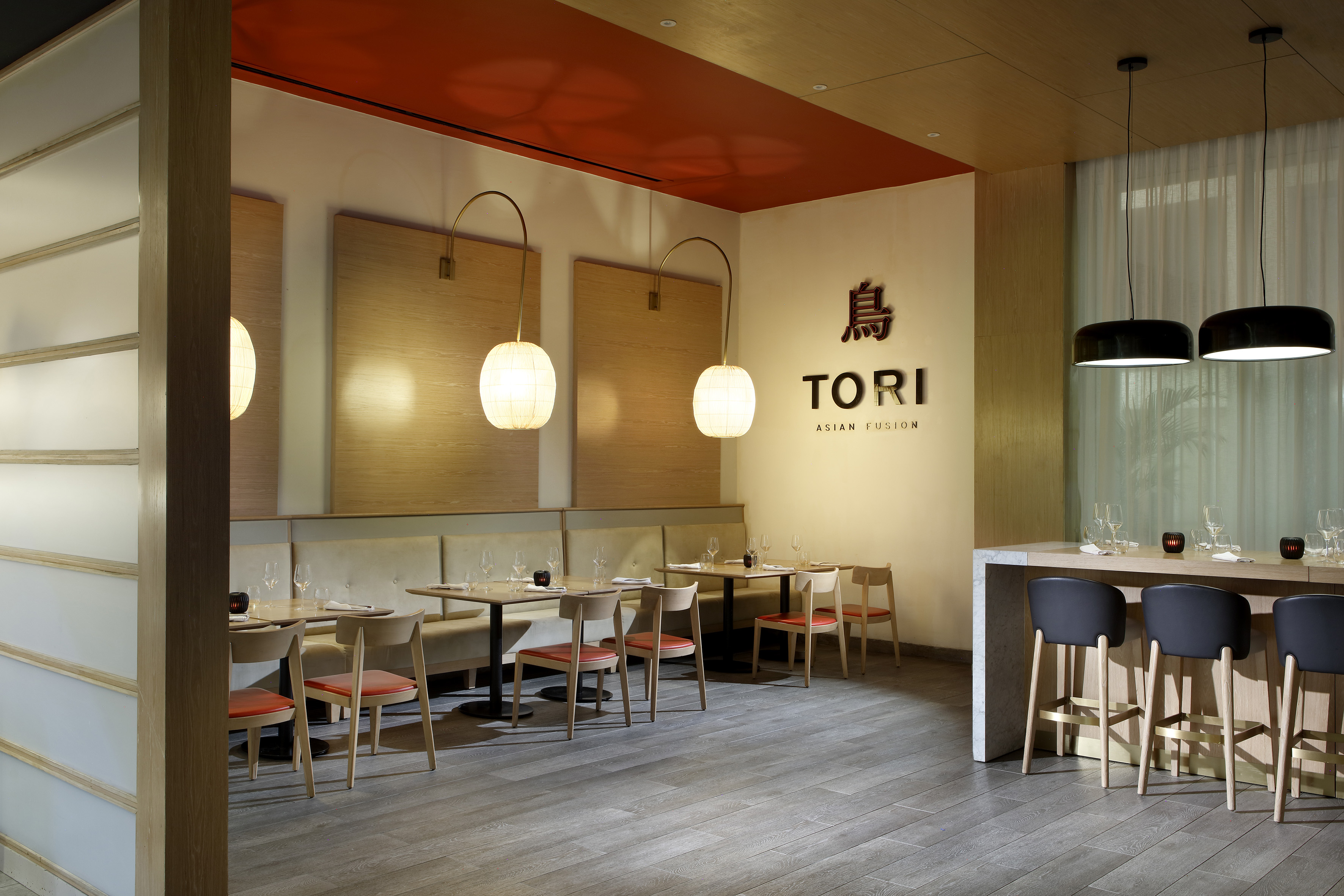 Tori Asian Fusion restaurant interior, modern dining tables, bar, wood accents.