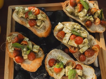 a group of sandwiches with tomatoes and cheese