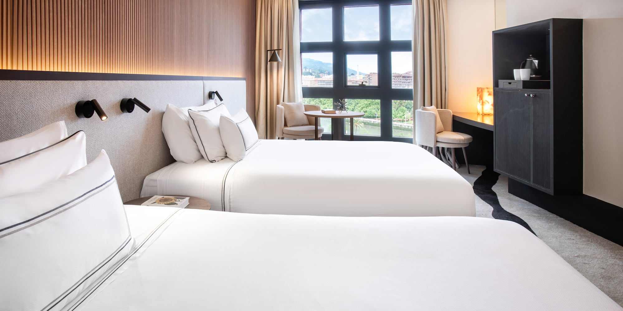 a room with two beds and a tv