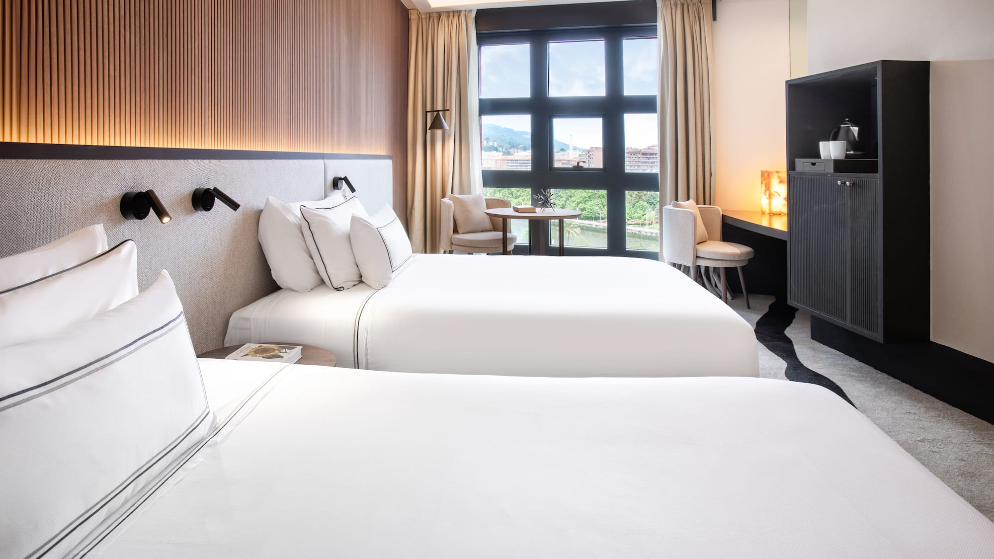 a room with two beds and a tv