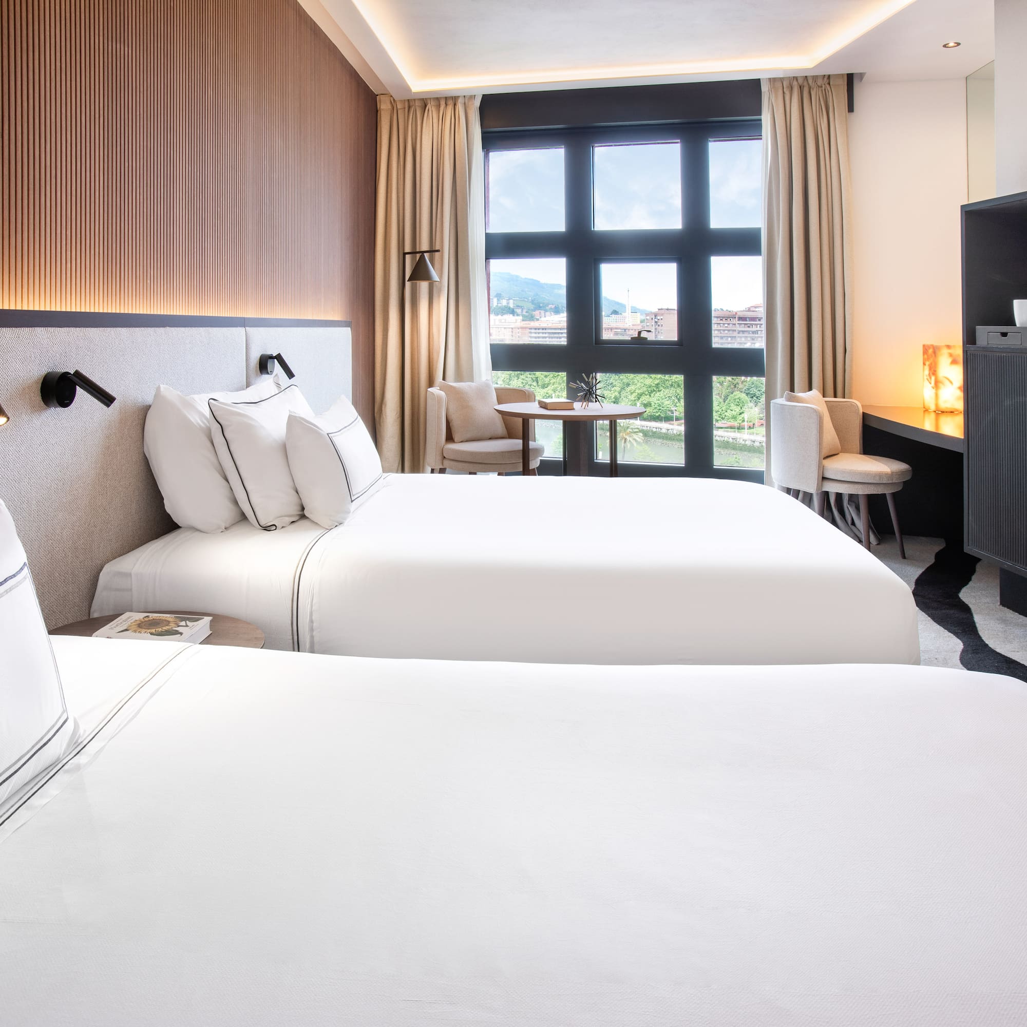 a room with two beds and a tv