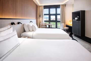 a room with two beds and a tv