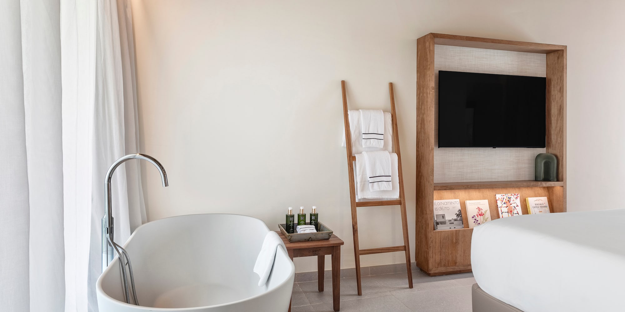 a bathroom with a tub and a tv