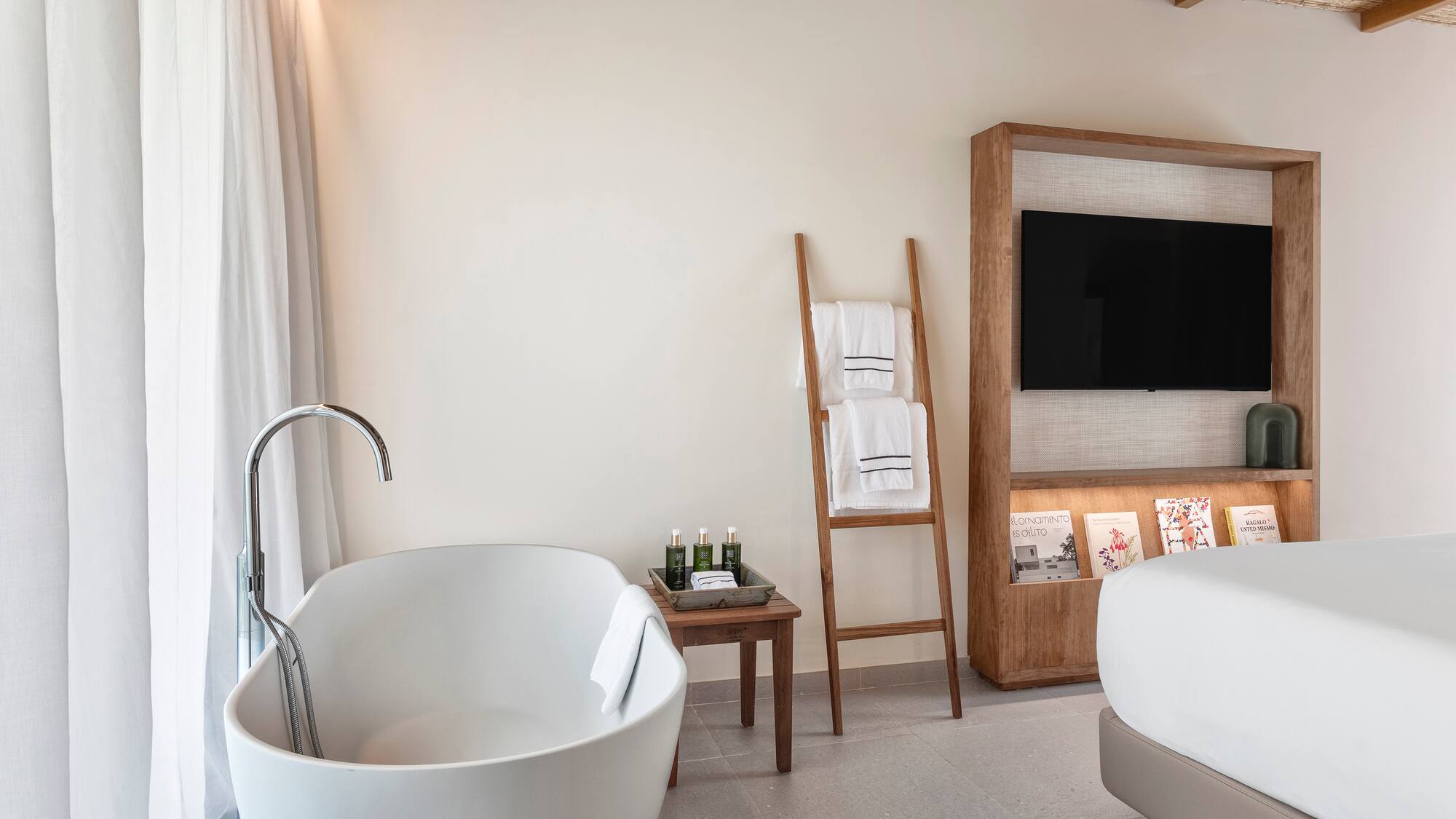 a bathroom with a tub and a tv