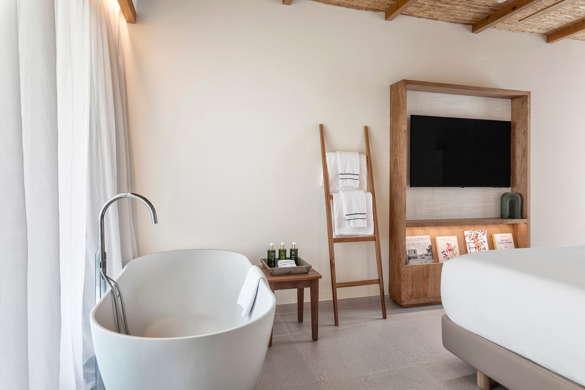 a bathroom with a tub and a tv