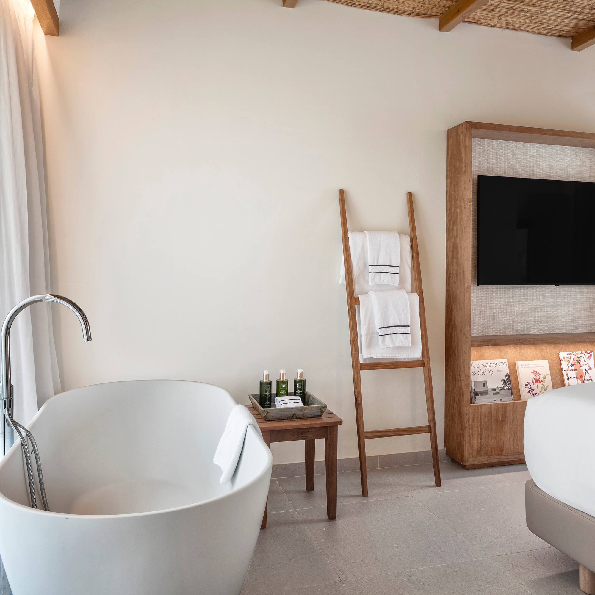 a bathroom with a tub and a tv
