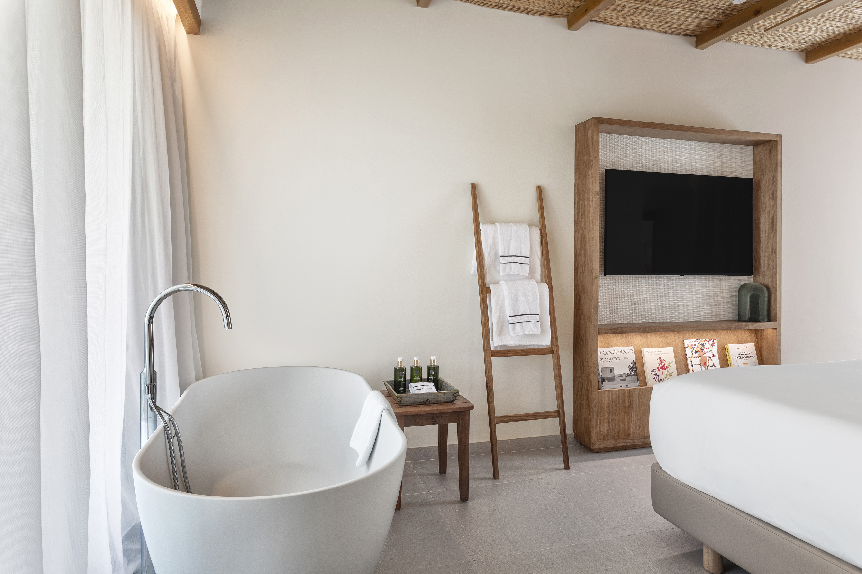 a bathroom with a tub and a tv