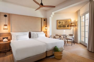 a room with two beds and a fan