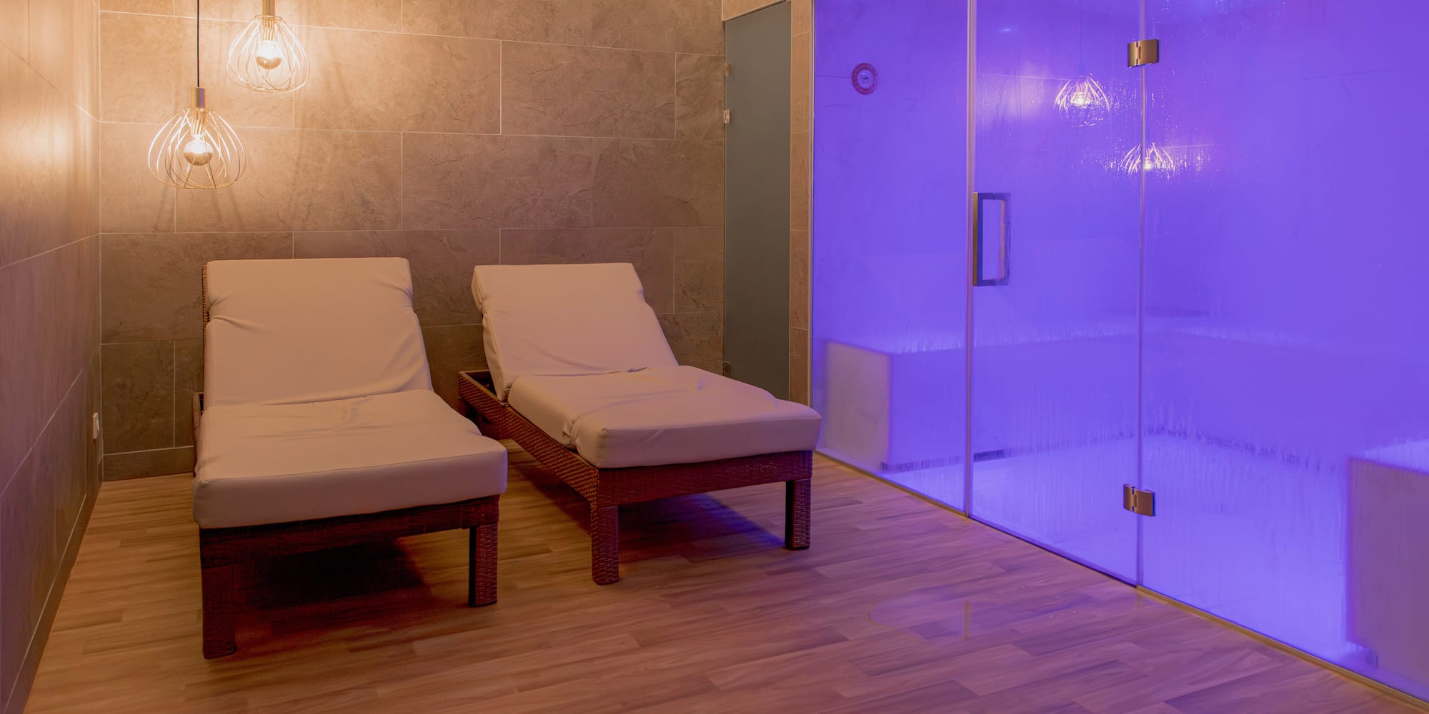 a room with chairs and a glass shower