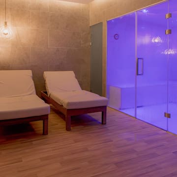 a room with chairs and a glass shower