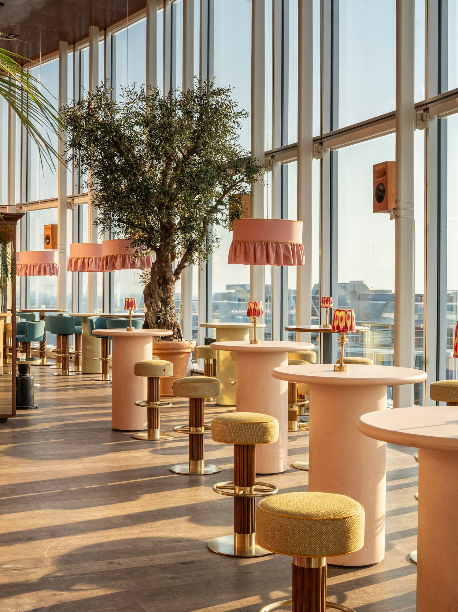 a room with tables and chairs and a tree