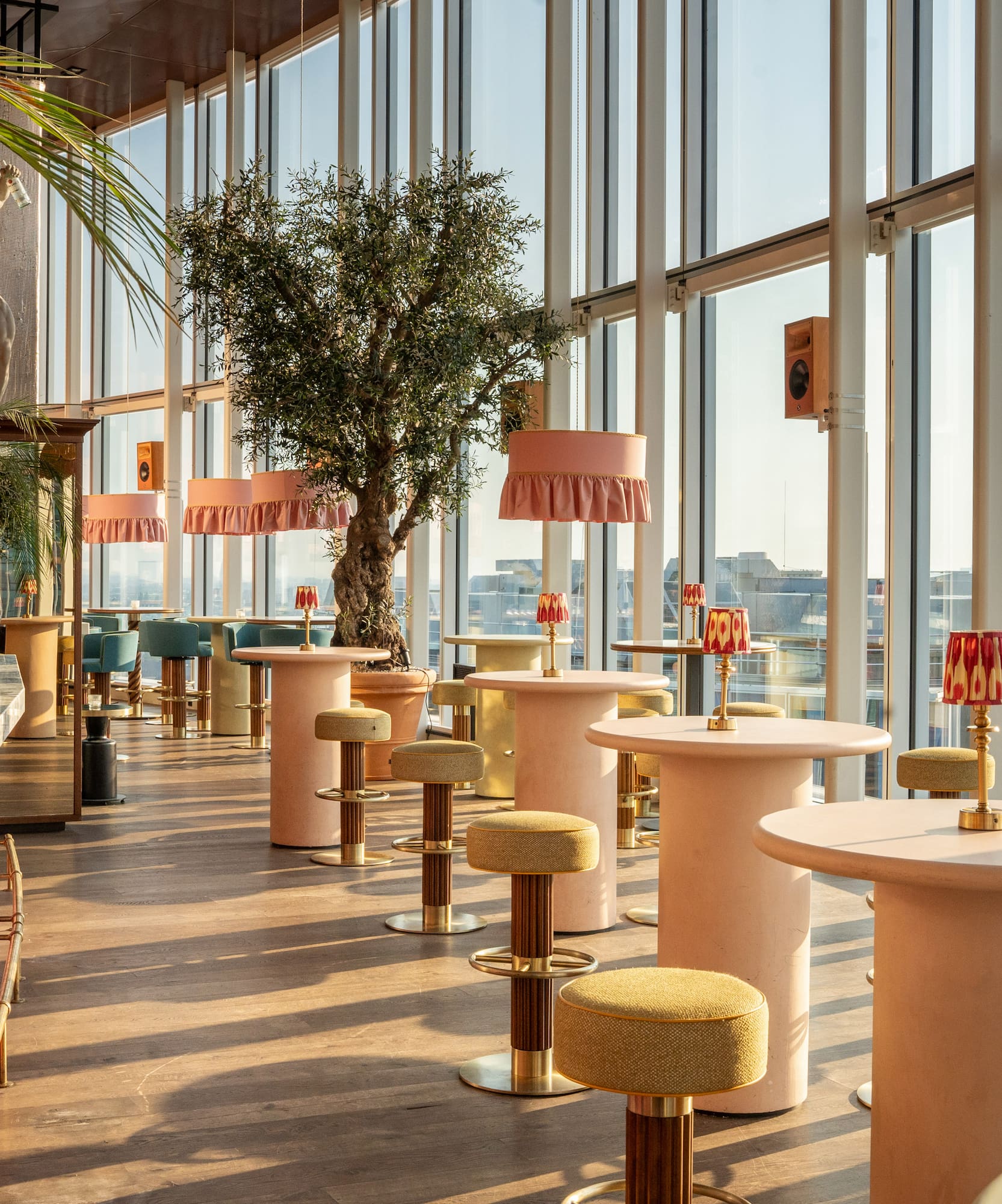 a room with tables and chairs and a tree