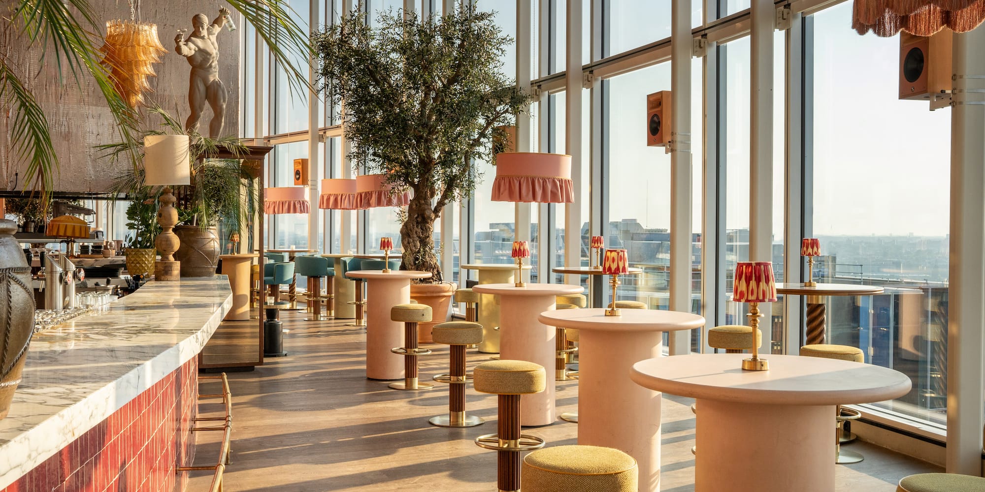 a room with tables and chairs and a tree