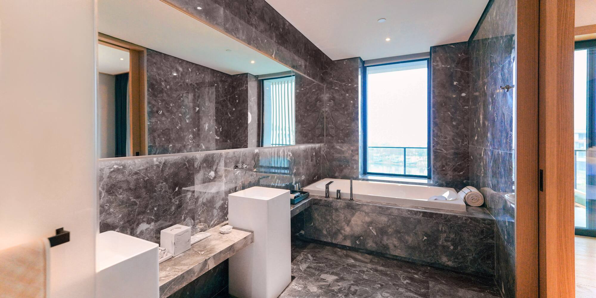 a bathroom with marble walls and a tub