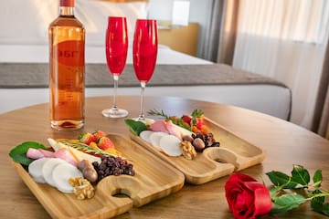 a couple of wooden plates with food on a table