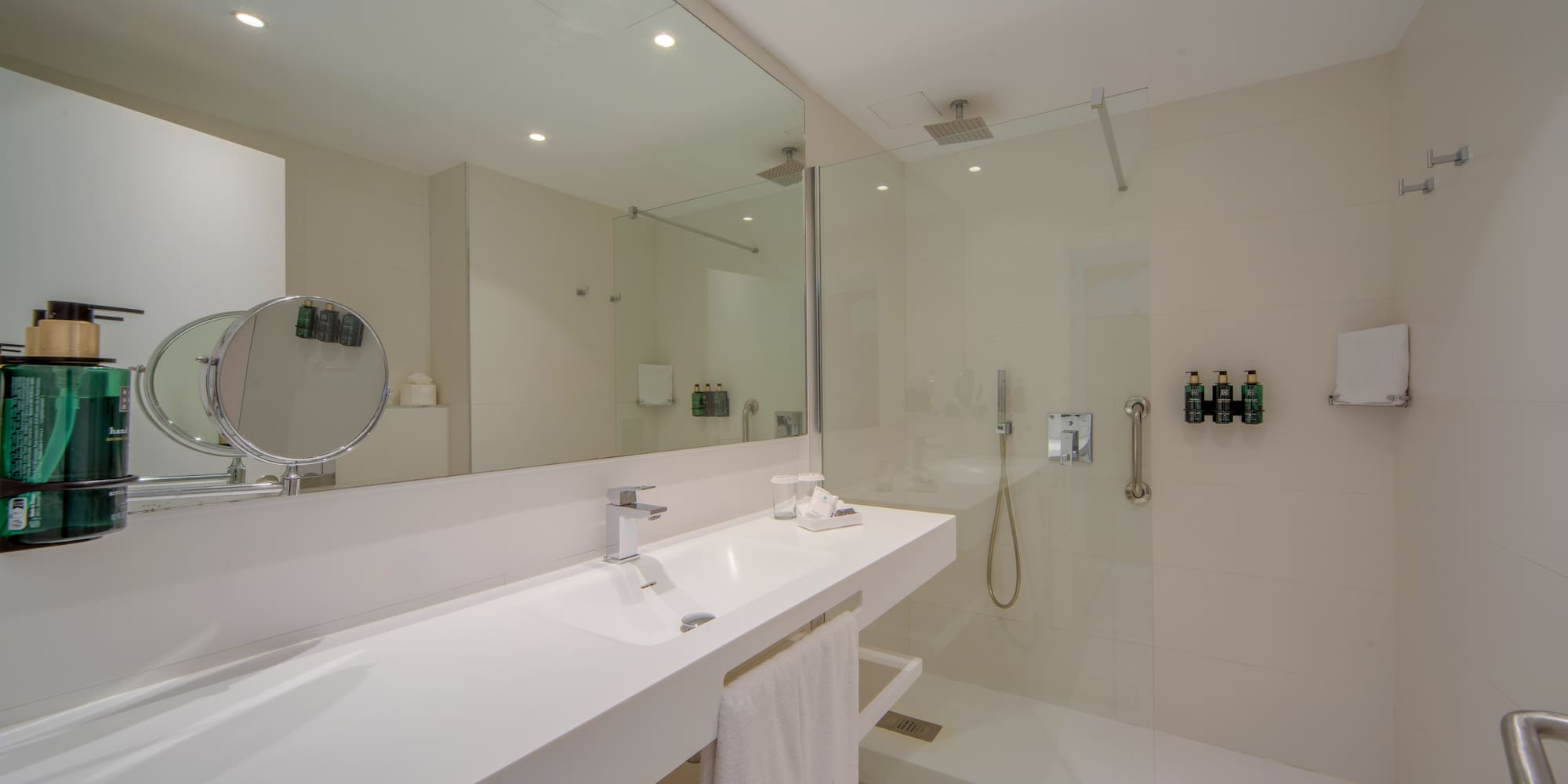 a bathroom with a glass shower and sink