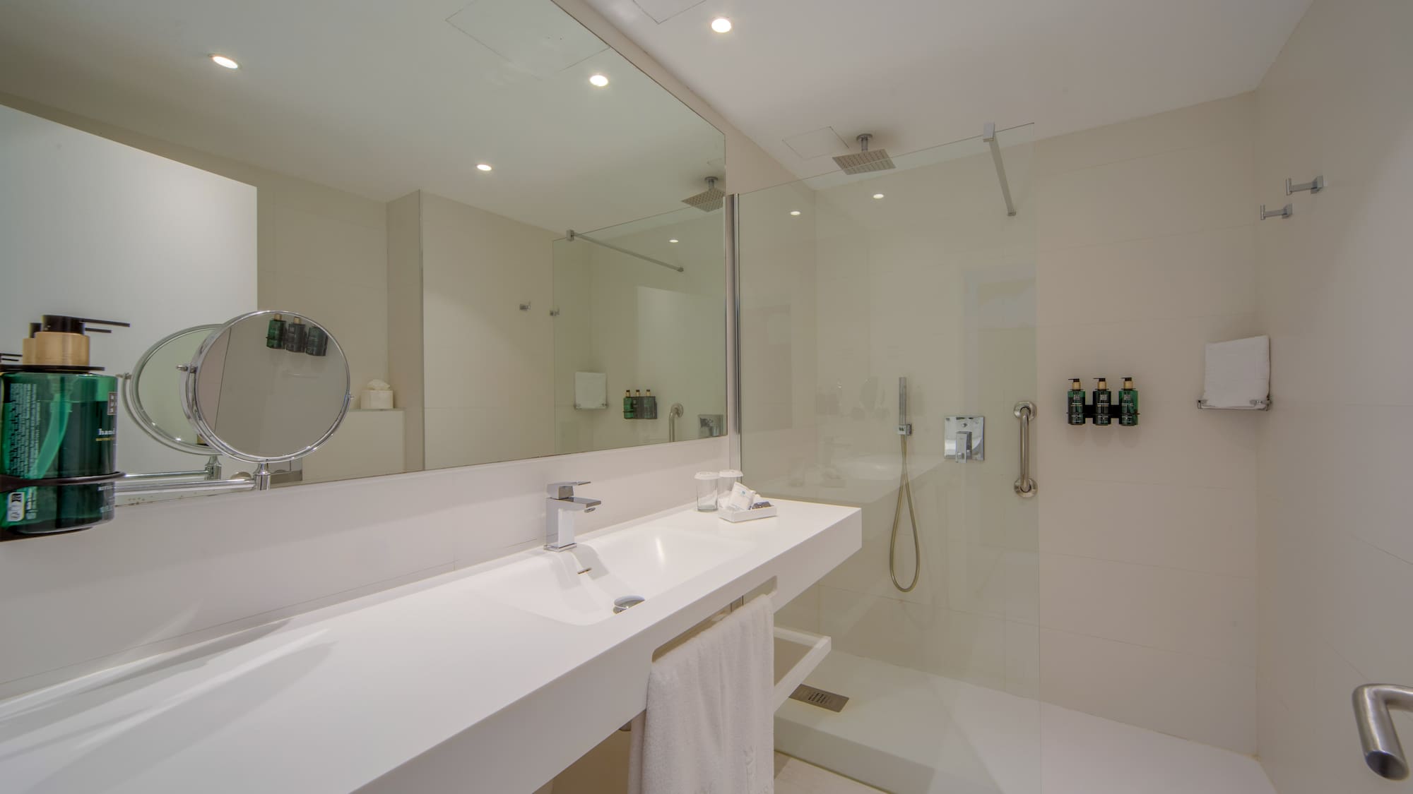a bathroom with a glass shower and sink